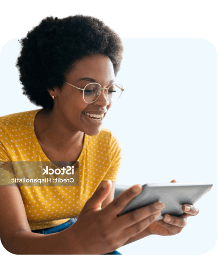 African American woman smiling at a tablet during a virtual dental consultation with a Dentistry.One dentist