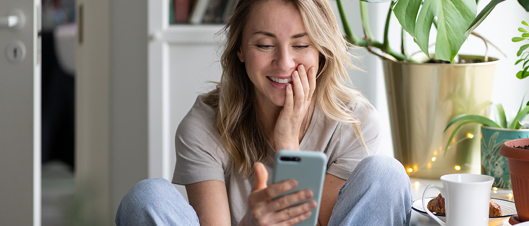 Smiling woman having a virtual dental consultation with a Dentistry.One dentist on her mobile device.