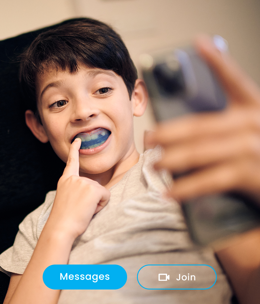 Young boy smiling during a personalized virtual dental consultation with a Dentistry.One dentist.