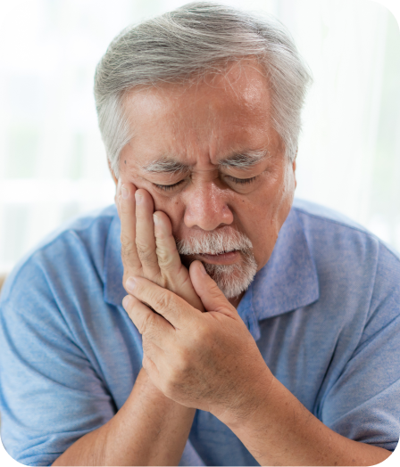 Older gentleman holding his cheek in pain, symbolizing the need for help with dental emergencies and care on the AMAC Partner Page.