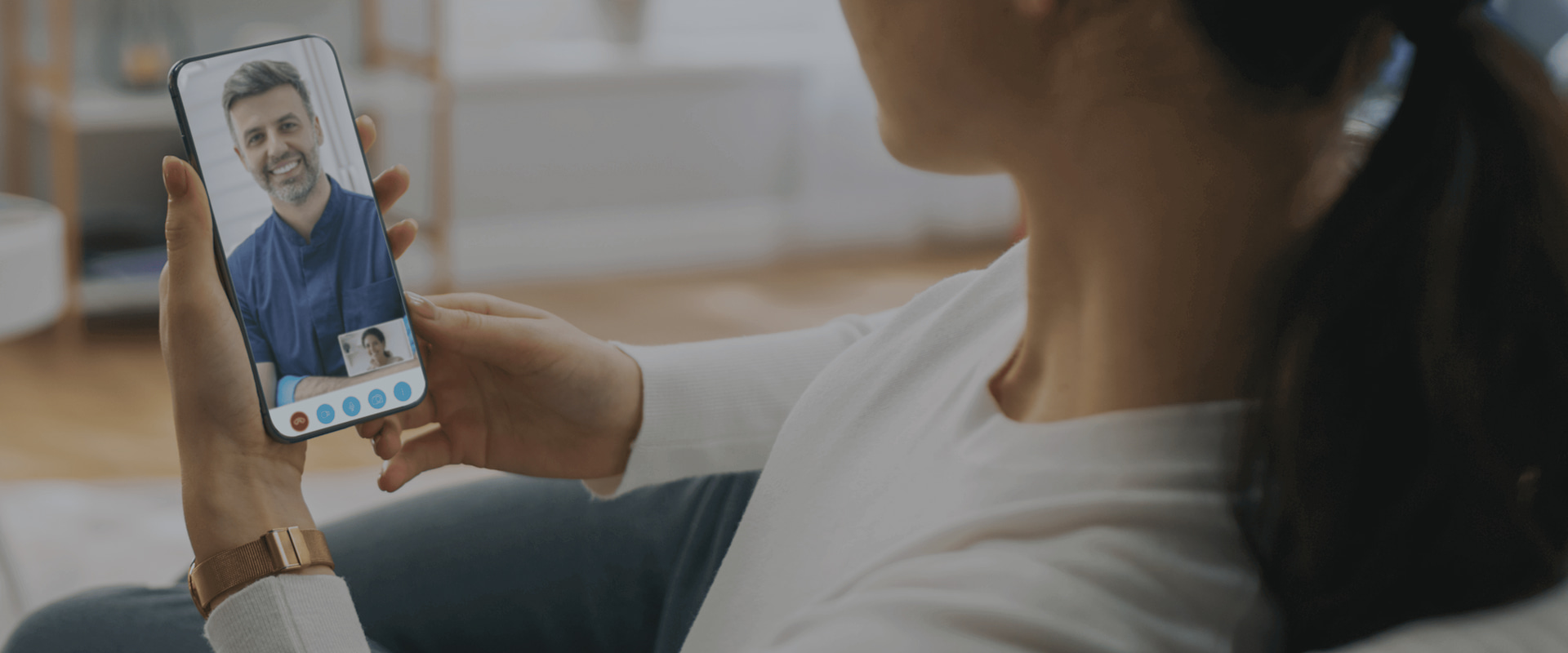 Virtual Consultation between a certified Dentistry.One provider and patient. Man and woman smiling at each other over the phone.