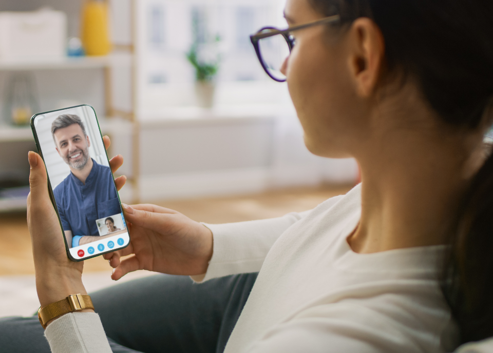 Woman having a virtual dental consultation with a Dentistry.One dentist, comfortably seated in her living room, showcasing the convenience of remote dental care.