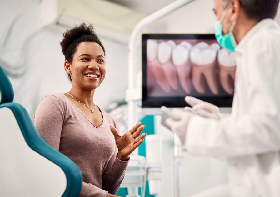 Woman talking to dentist about periodontal therapy