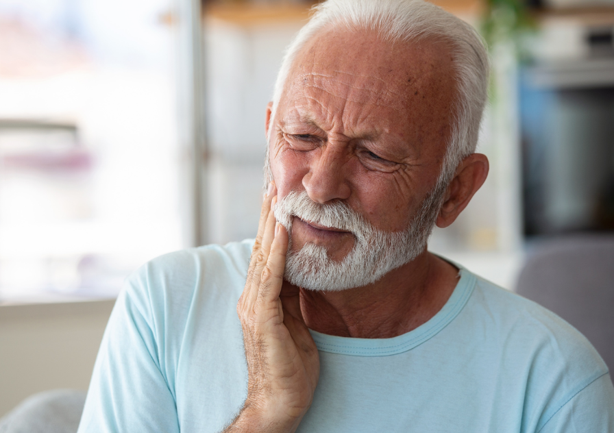 Man holding mouth in tooth pain