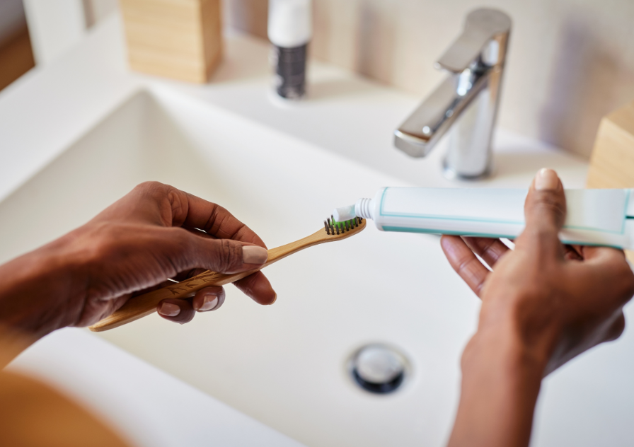 Woman applying toothpaste to prevent caivities