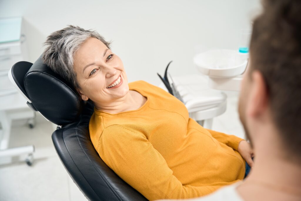 Woman talking to dentist about dental implants
