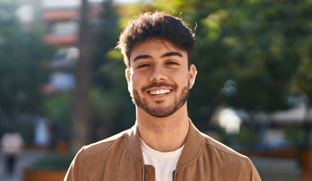 Man smiling after replacing missing teeth