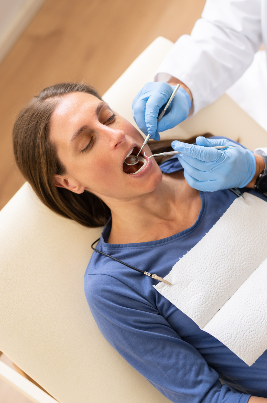 Pregnant woman in a dentist chair getting dental care.