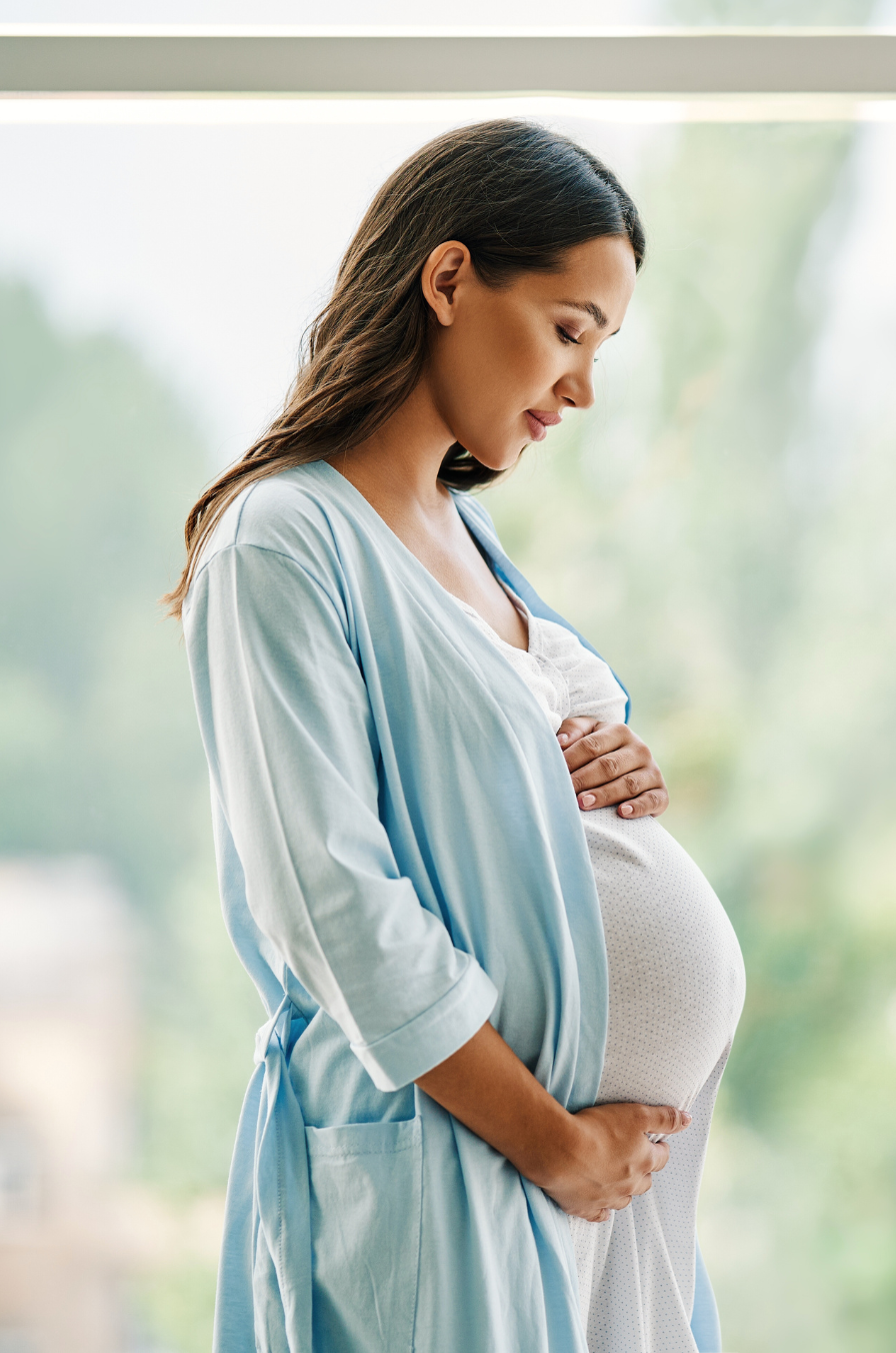 Pregnant woman looking down