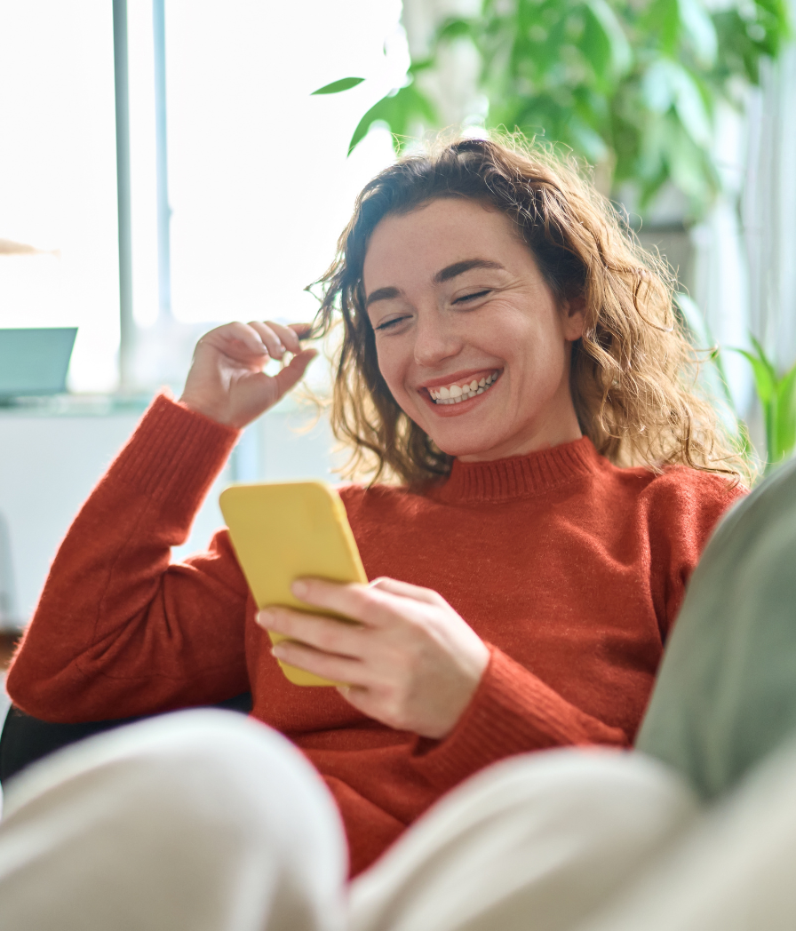 Woman talking to a dentist on her yellow phone.