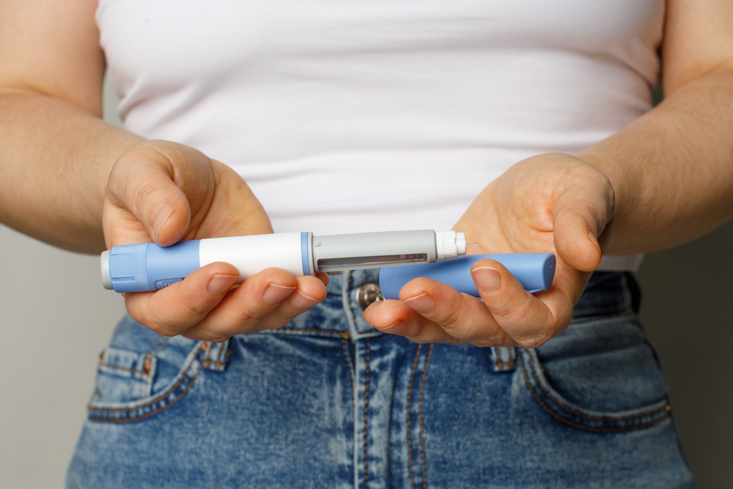 Woman holding ozempic shot in her hands.